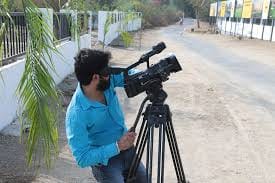 man shooting a video